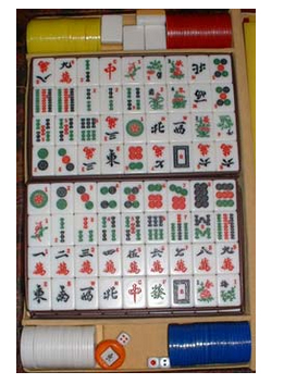 A foto ao lado mostra os componentes do Mahjong: as pedras (peças), as fichas de contagem e os dados. (Fonte: www.pt.wikipedia.org/wiki/Mahjong)